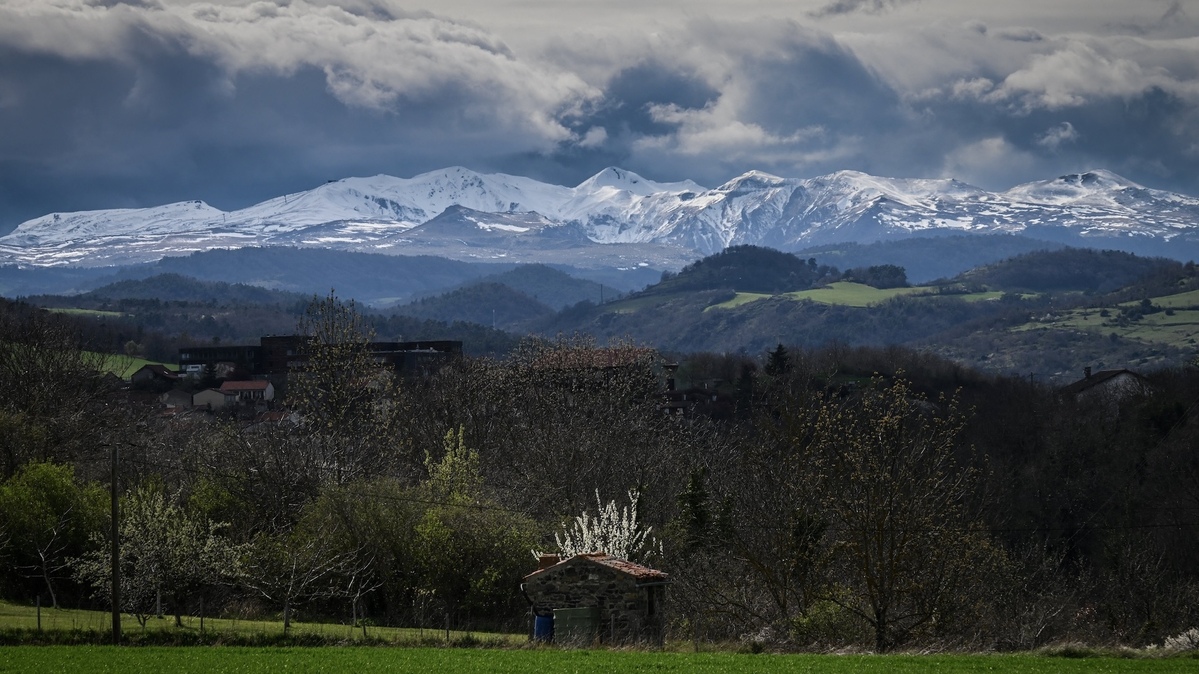 This photograph taken on March 27, 2024 in Champeix shows the valley of the Massif du Sancy mountain range in the heart of the French mountains Massif Central. (Photo by JEAN-PHILIPPE KSIAZEK / AFP)