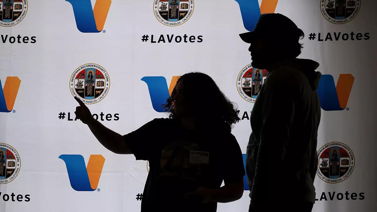 A polling worker helps direct a voter, right, at Beverly Hills City Hall on Tuesday, June 2, 2026, in Beverly Hills, California. (Christina House/Los Angeles Times/TNS)