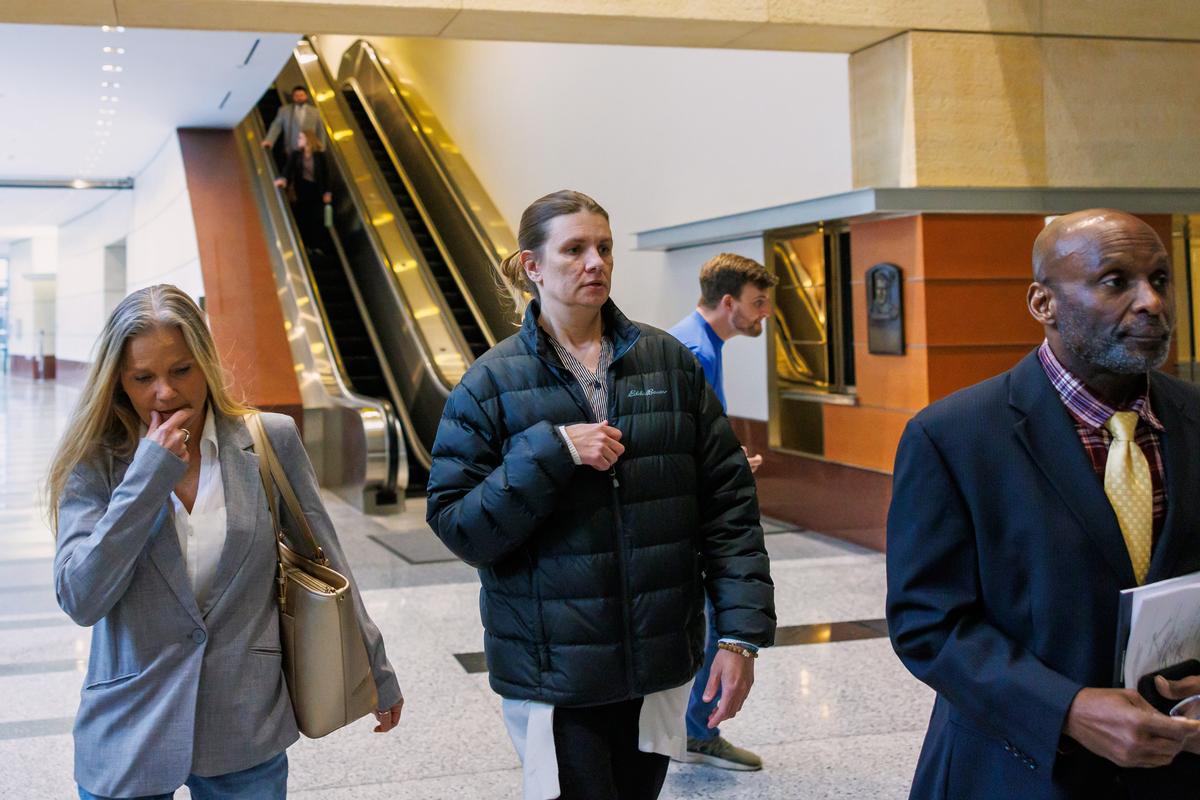  Aimee Bock (C), founder and executive director of Feeding Our Future, arrives at the Minneapolis federal courthouse on March 19, 2025. 
