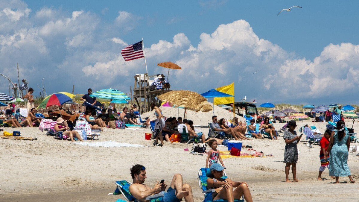 Beach. File photo: Americans sit on the beach on Fire Island Long Island New York in July 2021. 