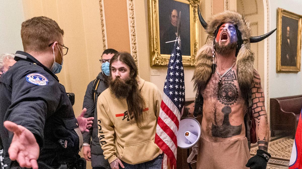 Jacob Chansley, right, was sentenced to prison for his role in the Jan. 6, 2021, attacks on the Capitol. An 11-year-old Shelby boy dressed up like Chansley for Halloween and won a costume contest.