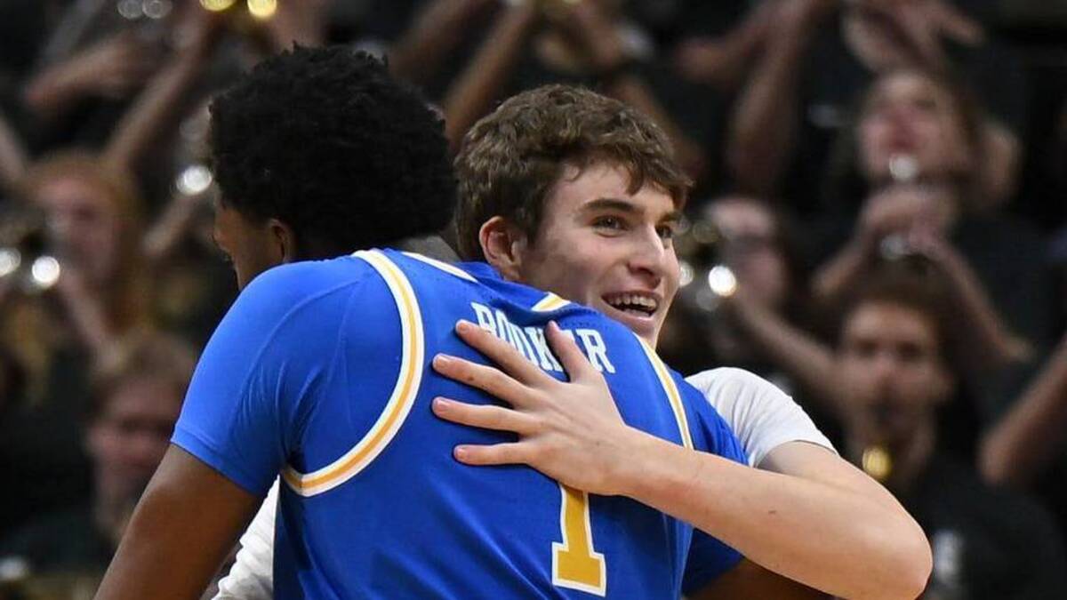  Michigan State's Colin Walton, right, hugs former Spartan and UCLA's Xavier Booker after the game on Tuesday, Feb. 17, 2026, at the Breslin Center in East Lansing. | Nick King/Lansing State Journal / USA TODAY NETWORK via Imagn Images 