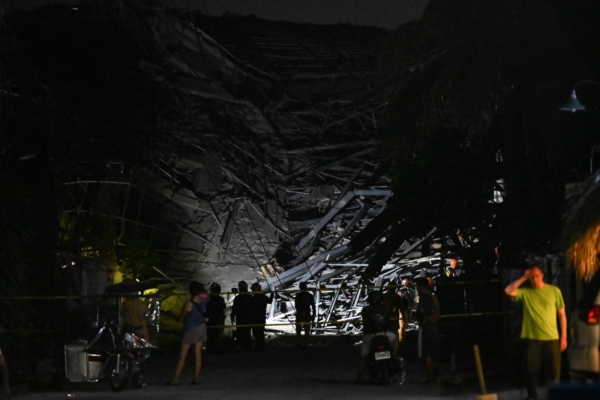 Rescue workers search for survivors among debris after a nine-story building under construction collapsed in Balibago, Angeles City, Pampanga, Philippines, May 24, 2026. REUTERS/Noel Celis
