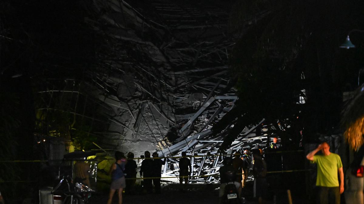 Rescue workers search for survivors among debris after a nine-story building under construction collapsed in Balibago, Angeles City, Pampanga, Philippines, May 24, 2026. REUTERS/Noel Celis