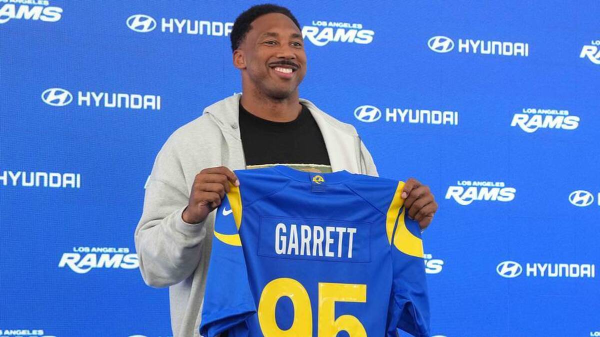  Jun 2, 2026; Woodland Hills, CA, USA; Los Angeles Rams defensive end Myles Garrett (95) poses with jersey at press conference at Rams Practice Facility. Mandatory Credit: Kirby Lee-Imagn Images | Kirby Lee-Imagn Images 