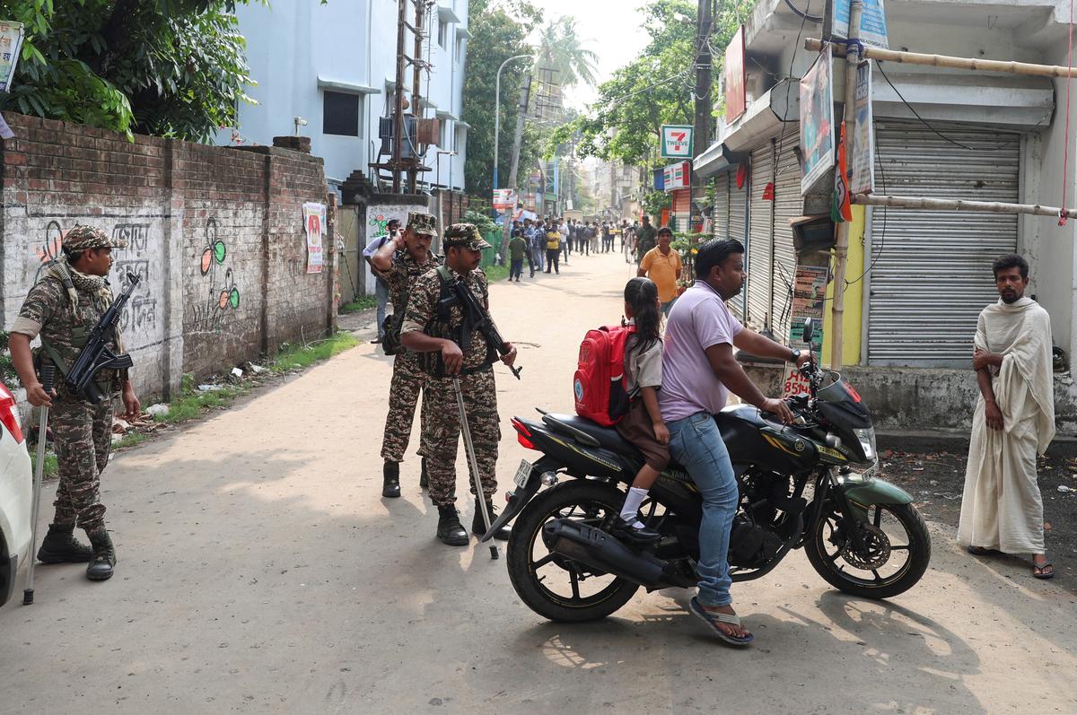 Members of security forces stop vehicles as they stand guard along a road leading to the site where an aide of Suvendu Adhikari, a leader of Bharatiya Janata Party (BJP) in West Bengal state, was shot dead days after the BJP secured a majority in the state assembly elections, in North 24 Parganas, on the outskirts of Kolkata, India, May 7, 2026. REUTERS/Sahiba Chawdhary