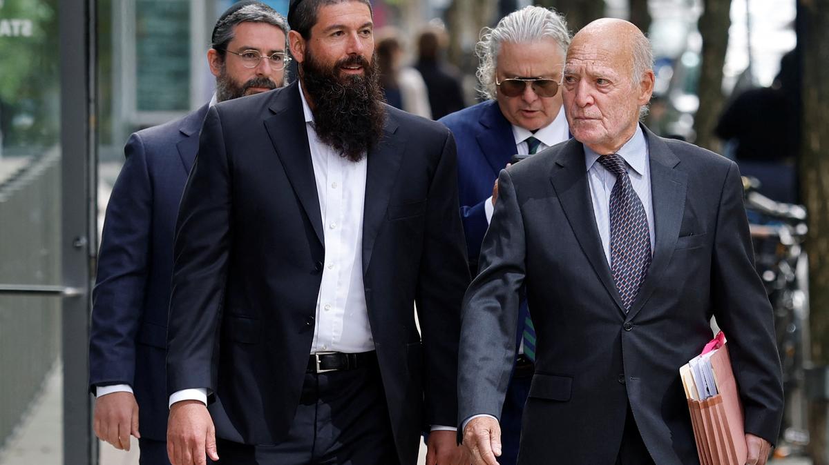 Nicolo Nourafchan, second from left, and Lorenzo Nourafchan, left, arrive on Monday at the Boston federal courthouse, where they are facing charges with participating in an insider trading scheme in which attorneys at major law firms passed tips on merger deals to a network of individuals who traded on the information.