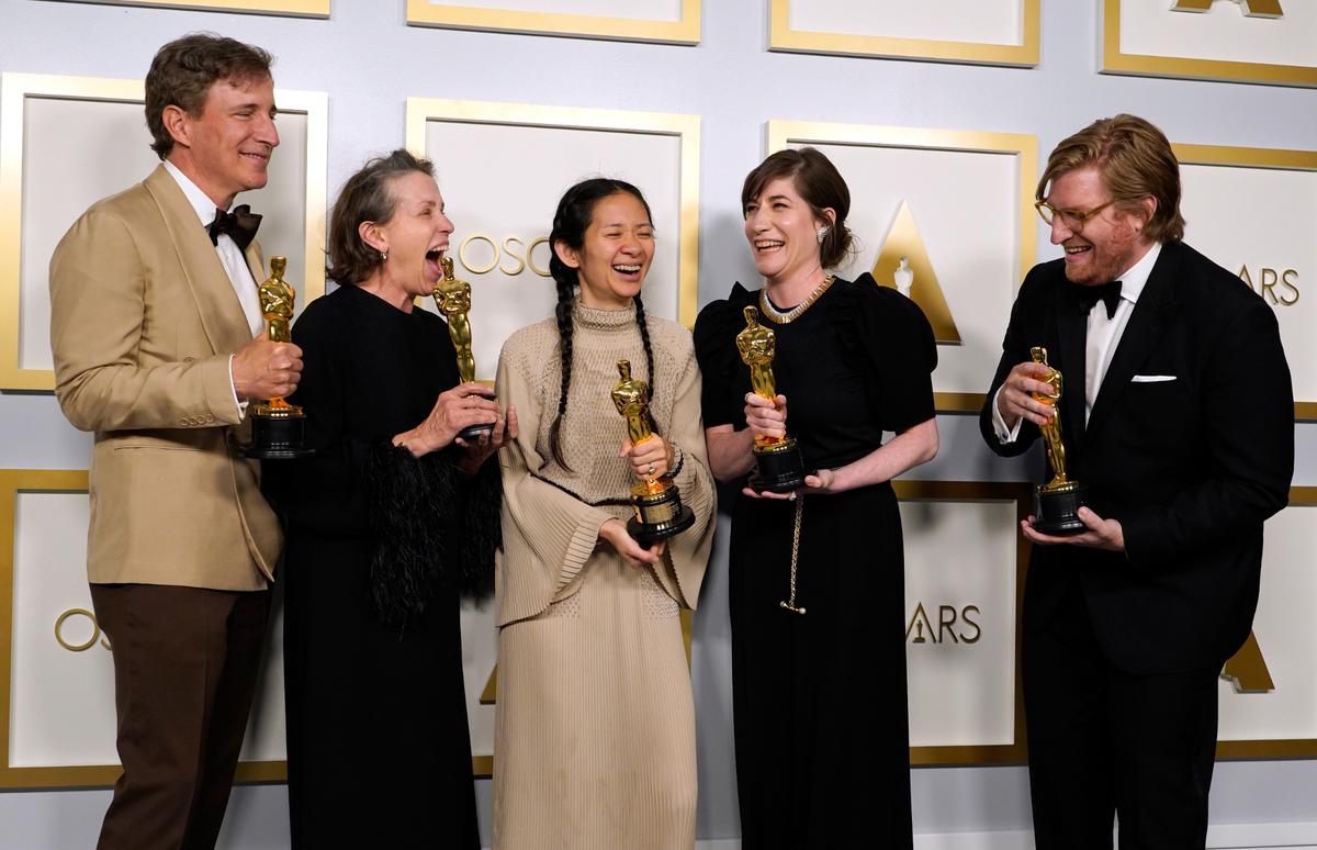 Producers Peter Spears of Kansas City, from left, Frances McDormand, Chloe Zhao, Mollye Asher and Dan Janvey, winners of the award for best picture for “Nomadland,” pose in the press room at the Oscars on Sunday at Union Station in Los Angeles.