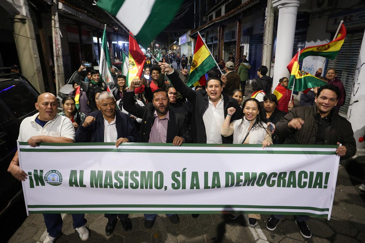 Demonstrators hold a sign reading 'No to MAS, yes to democracy', referring to the political party Movement for Socialism, during a march calling for an end to protest blockades that have contributed to shortages of food, medical supplies and fuel, in Santa Cruz, Bolivia May 21, 2026. REUTERS/Ipa Ibanez