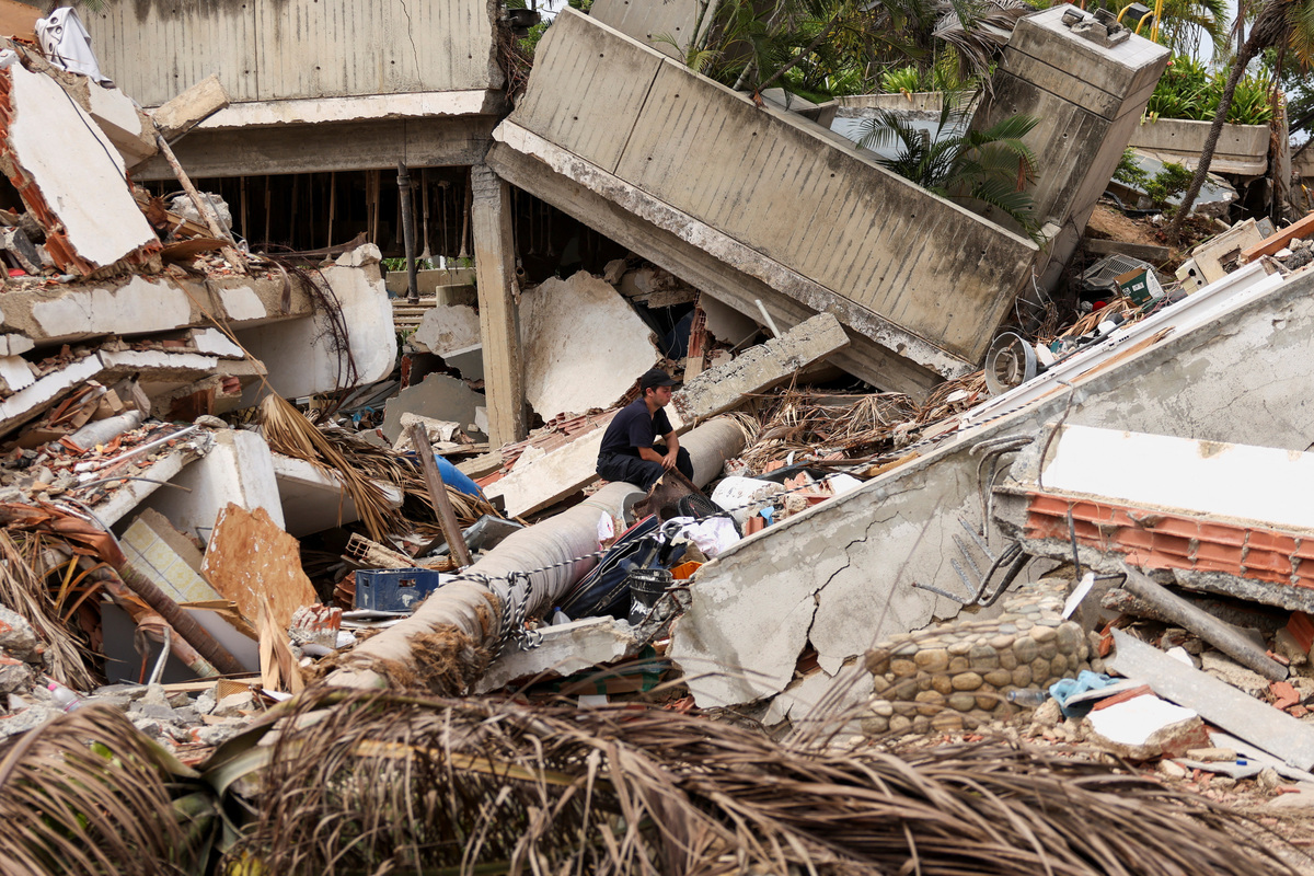 A man pauses while searching for his family members beneath the rubble in the aftermath of the June 24 earthquakes in Los Corales, La Guaira, Venezuela, July 4, 2026. REUTERS/Leonardo Fernandez Viloria