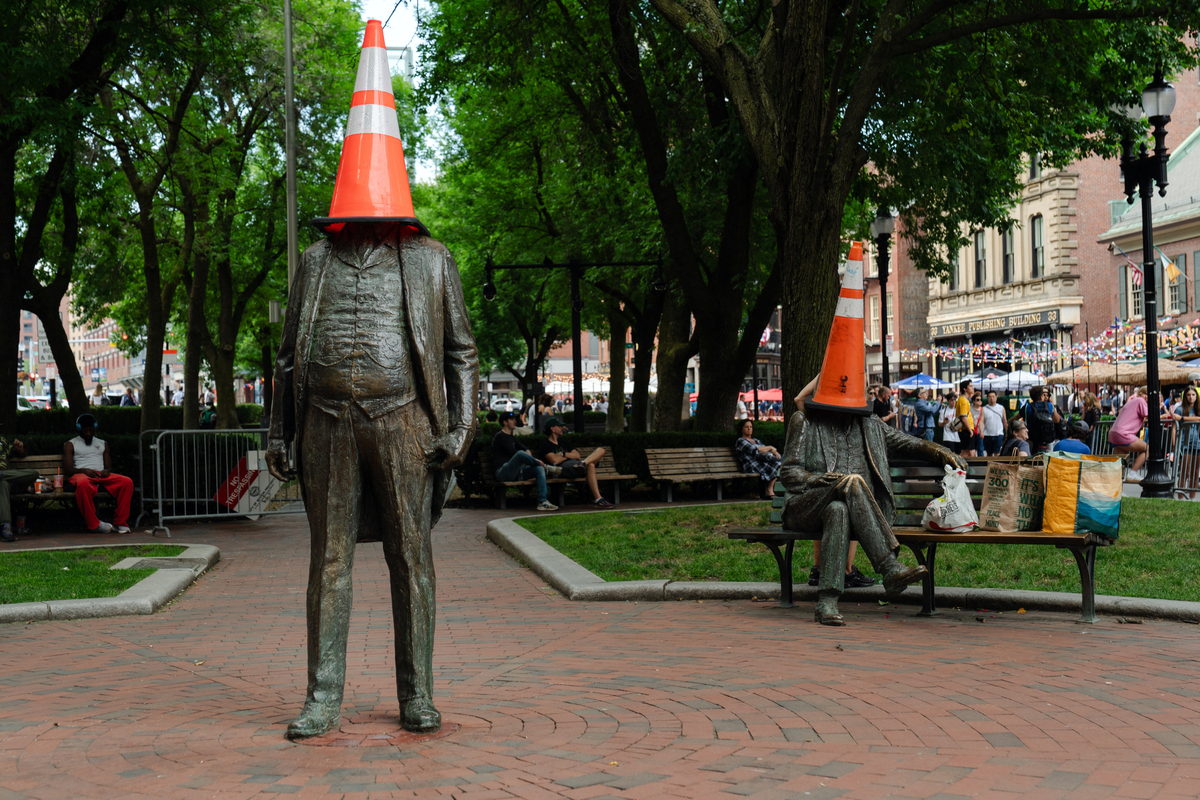 Traffic cones sit atop statues of former Boston Mayor James Michael Curley in Boston on June 17, 2026. The Tartan Army -- thousands of soccer fans from Scotland, here to see their national team play outside Boston in two matches of the World Cup -- are packing this old city's narrow streets, its subway cars, restaurants and pubs, and filling the air with the cry of bagpipes. (Sophie Park/The New York Times)