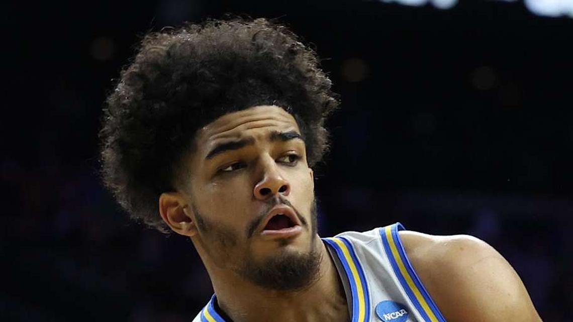  Mar 20, 2026; Philadelphia, PA, USA; UCLA Bruins guard Eric Freeny (8) makes a pass against UCF Knights center John Bol (7) in the second half during a first round game of the men's 2026 NCAA Tournament at Xfinity Mobile Arena. Mandatory Credit: Bill Streicher-Imagn Images | Bill Streicher-Imagn Images 