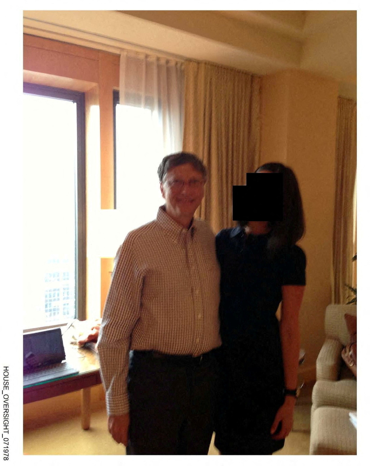 FILE PHOTO: Bill Gates appears with a woman, whose identity has been obscured, in this image from the Epstein estate released by House Oversight Committee Democrats in Washington, D.C., U.S., on December 18, 2025. House Oversight Committee Democrats/Handout via REUTERS/File Photo