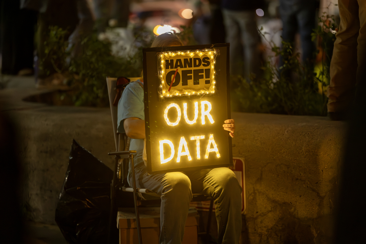  A demonstrator expresses concerns over the sharing of private personal data by DOGE, at a “Hands Off!” protest against the Trump administration on April 5, 2025, in Riverside, California. 