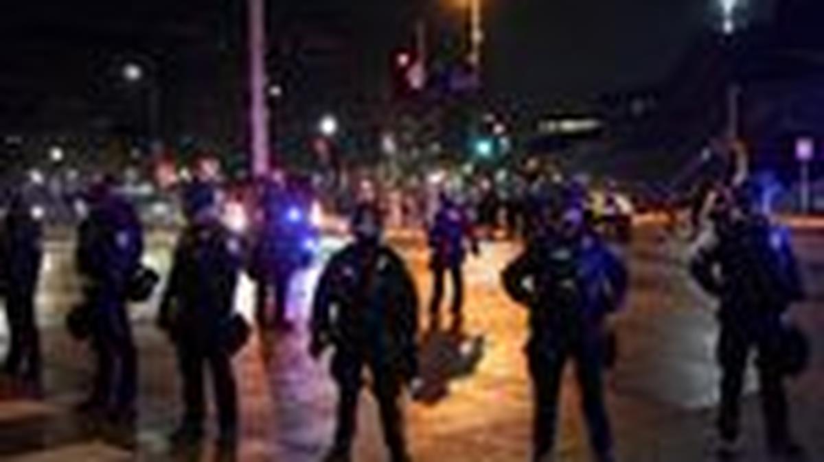 Police officers stand guard after declaring unlawful assembly, as demonstrators gathered outside a hotel they believe is being used by federal agents, amid increased immigration enforcement in Minneapolis, Minnesota, U.S., February 5, 2026. REUTERS/Seth Herald