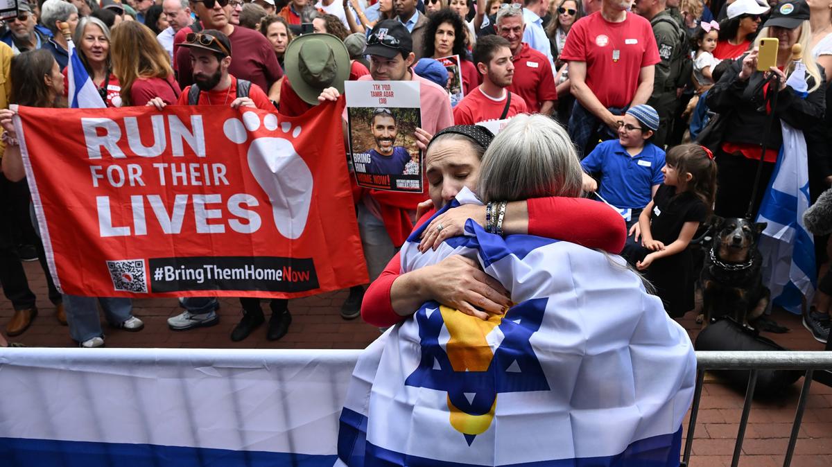 Rachel Amaru, right, hugs Rachel Cohen during a remembrance program at the Boulder Jewish Festival on the Pearl Street Mall in Boulder on June 8, 2025. Cohen was on the pedestrian mall a week earlier during the antisemitic terror attack with her two kids. (Helen H. Richardson/The Denver Post/TNS)