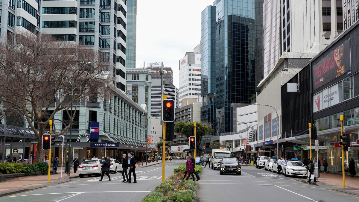 People cross the road at Lambton Quay in Wellington, New Zealand, September 24, 2025. REUTERS/Marty Melville