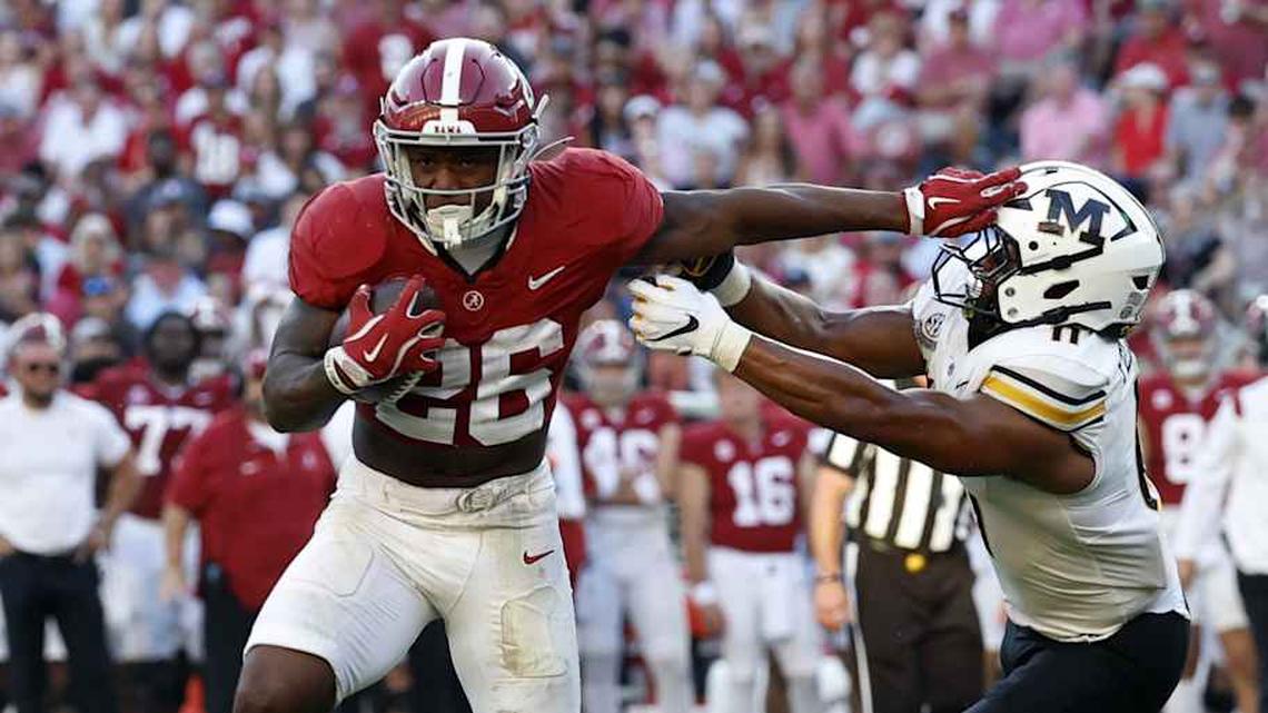  Oct 26, 2024; Tuscaloosa, Alabama, USA; Alabama Crimson Tide running back Jam Miller (26) stiff arms Missouri Tigers linebacker Corey Flagg Jr. (11) as he carries the ball in for a touchdown during the second half at Bryant-Denny Stadium. Mandatory Credit: Butch Dill-Imagn Images | Butch Dill-Imagn Images 