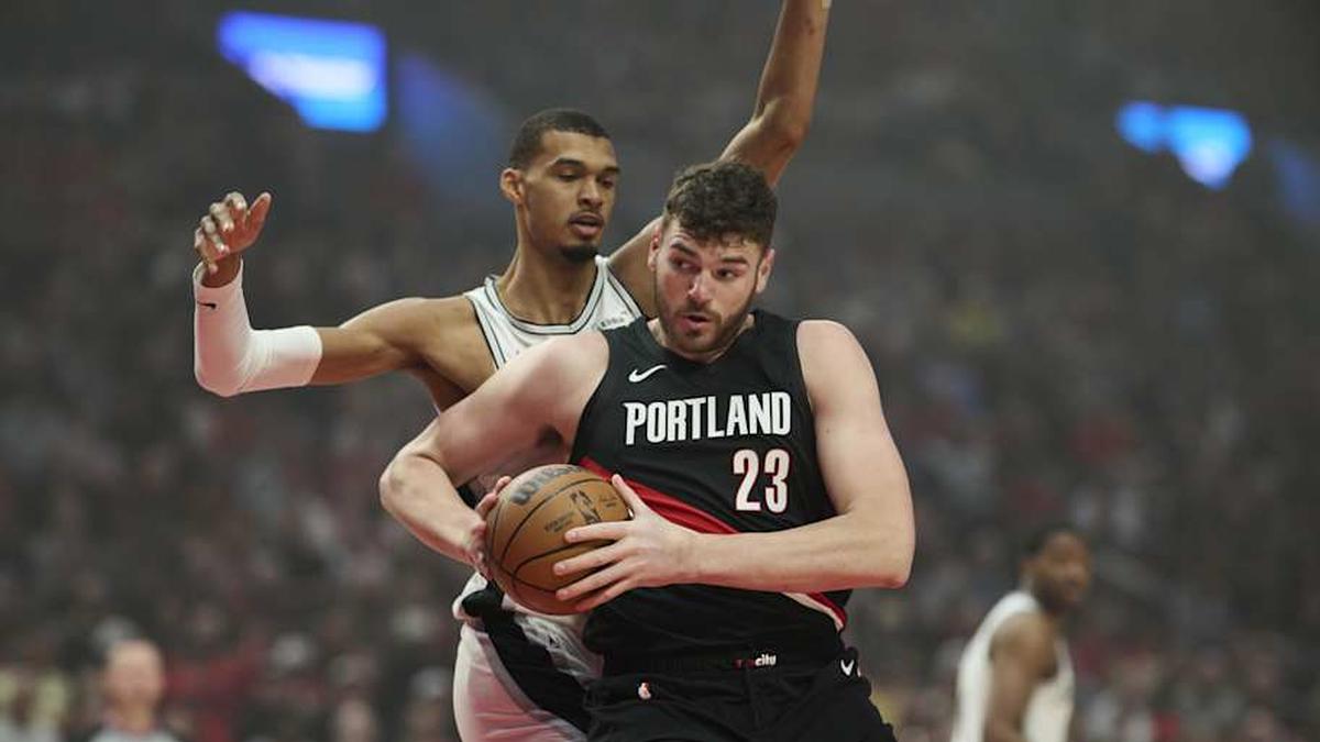  Apr 26, 2026; Portland, Oregon, USA; Portland Trail Blazers center Donovan Clingan (23) goes up for a basket during the first half against San Antonio Spurs forward Victor Wembanyama (1) during game four of the first round of the 2026 NBA Playoffs at Moda Center. | Troy Wayrynen-Imagn Images 