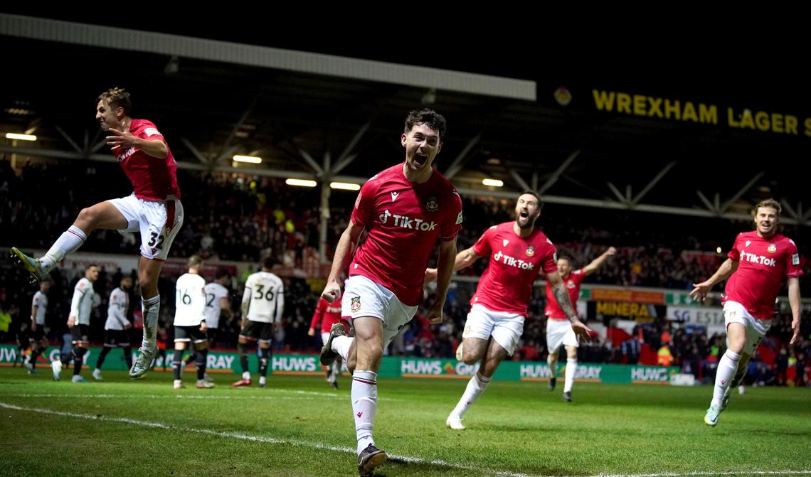 Wrexham’s Tom O’Connor celebrates scoring against Sheffield United during the English FA Cup fourth round soccer match at The Racecourse Ground, Wrexham, Wales, Sunday Jan. 29, 2023.