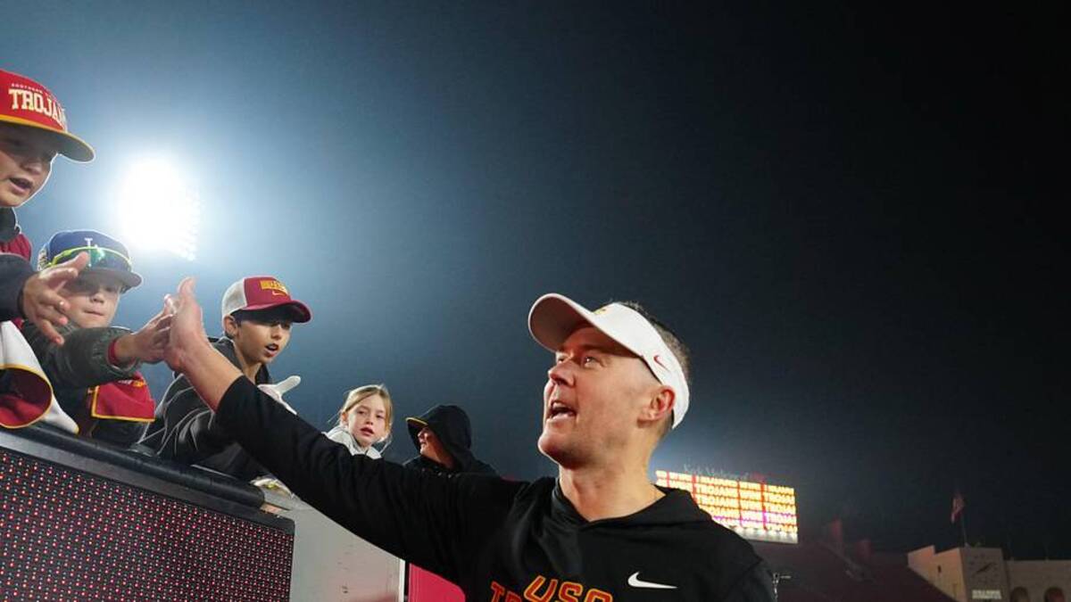  Nov 29, 2025; Los Angeles, California, USA; Southern California Trojans head coach Lincoln Riley celebrates with fans after the game against the UCLA Bruins at United Airlines Field at Los Angeles Memorial Coliseum. Mandatory Credit: Kirby Lee-Imagn Images | Kirby Lee-Imagn Images 