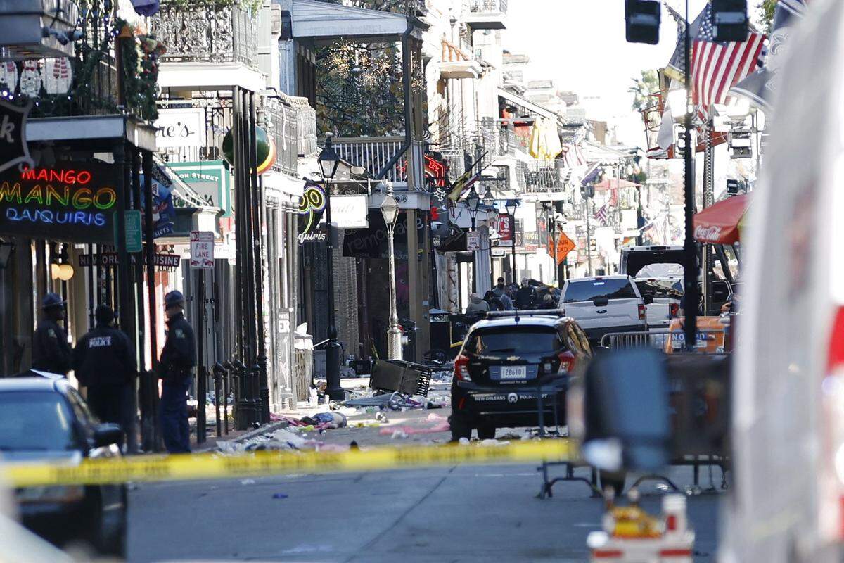A view down Bourbon Street on Jan. 1, 2025, shows a crashed white pickup truck, right, after an attack during New Year’s Eve celebrations in New Orleans.