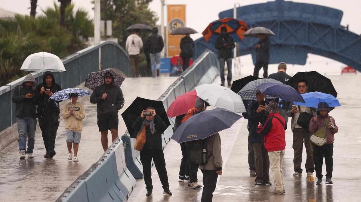 People on the Santa Monica Pier during a morning downpour in Santa Monica, California, on Nov. 15, 2025. (Genaro Molina/Los Angeles Times/TNS)