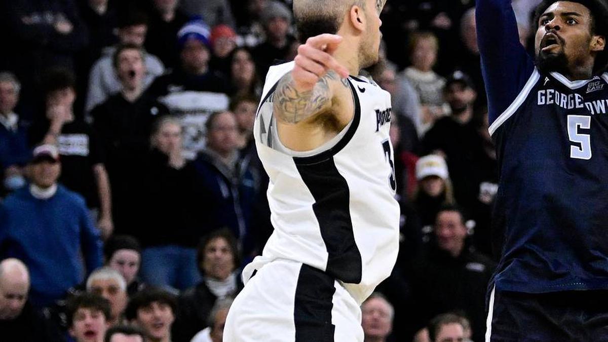  Jan 24, 2026; Providence, Rhode Island, USA; Georgetown Hoyas guard KJ Lewis (5) makes a three point basket over Providence Friars forward Duncan Powell (31) during the second half at Amica Mutual Pavilion. Mandatory Credit: Eric Canha-Imagn Images | Eric Canha-Imagn Images 