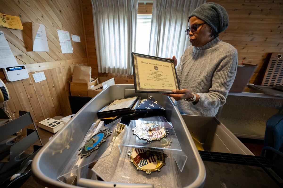 Karen Wilson, DAV Chapter 6's former adjutant, shows off some of the memorabilia the group is packing up. (Photo by Paul Kitagaki Jr. for the Sacramento Bee)