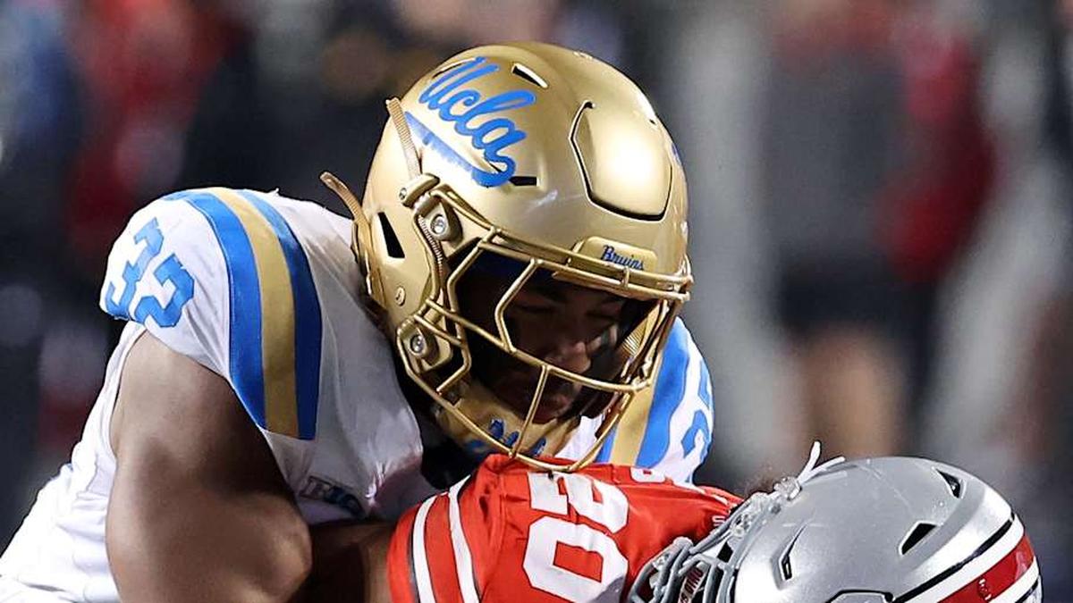  Nov 15, 2025; Columbus, Ohio, USA; Ohio State Buckeyes running back James Peoples (20) runs the ball as UCLA Bruins linebacker Isaiah Chisom (32) makes the tackle during the fourth quarter at Ohio Stadium. Mandatory Credit: Joseph Maiorana-Imagn Images | Joseph Maiorana-Imagn Images 