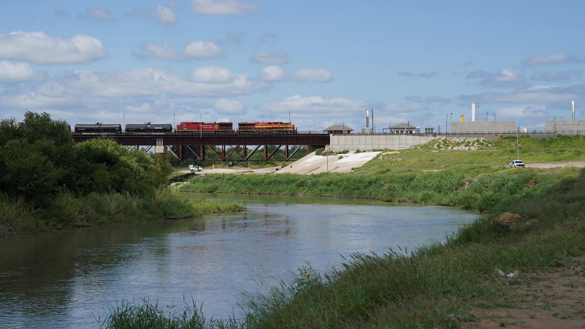 A freight train coming from Mexico crosses the border after six bodies were found on Sunday in a train boxcar, in Laredo, Texas, U.S. May 11, 2026.  REUTERS/Gabriel V. Cardenas