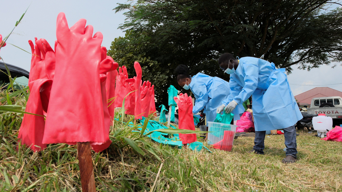Medical workers in personal protective equipment (PPE) sanitise and wash their hands at an Ebola treatment centre during a ceremony to present recovery certificates to patients at the Rwambara General Reference Hospital in Bunia, eastern Democratic Republic of Congo, June 16, 2026. REUTERS/Gradel Muyisa Mumbere