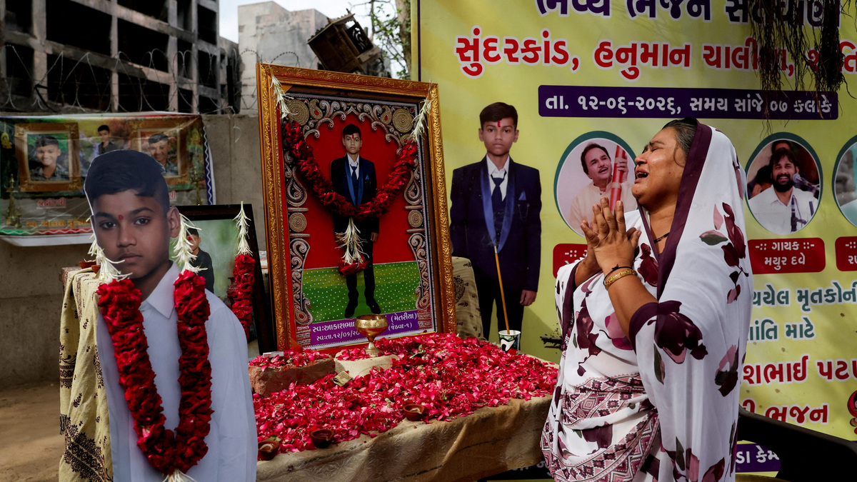 Sita Patni, a survivor and the mother of Akash Patni, 14, who died in an Air India Boeing 787-8 Dreamliner crash on June 12, 2025, mourns in front of her son's portrait near the crash site during the first anniversary in Ahmedabad, India, June 12, 2026. REUTERS/Amit Dave     TPX IMAGES OF THE DAY