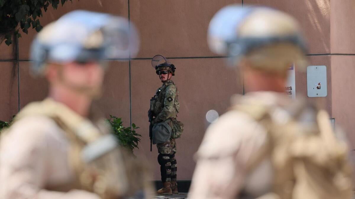 U.S. Marines frame a California National Guardsman stationed outside the federal detention center in downtown Los Angeles on June 17. The Republican-led House passed a resolution condemning violence against law enforcement and calling for cooperation between local and federal officials.