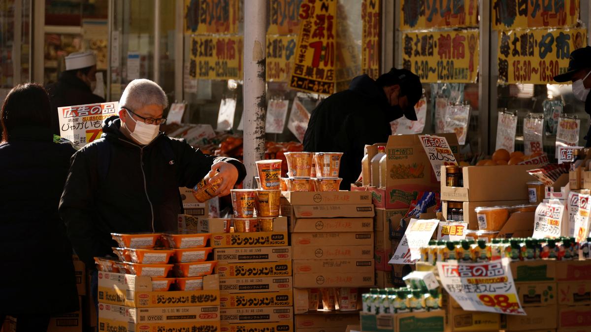 Shoppers check foods at a supermarket in Tokyo, Japan January 10, 2023. REUTERS/Issei Kato