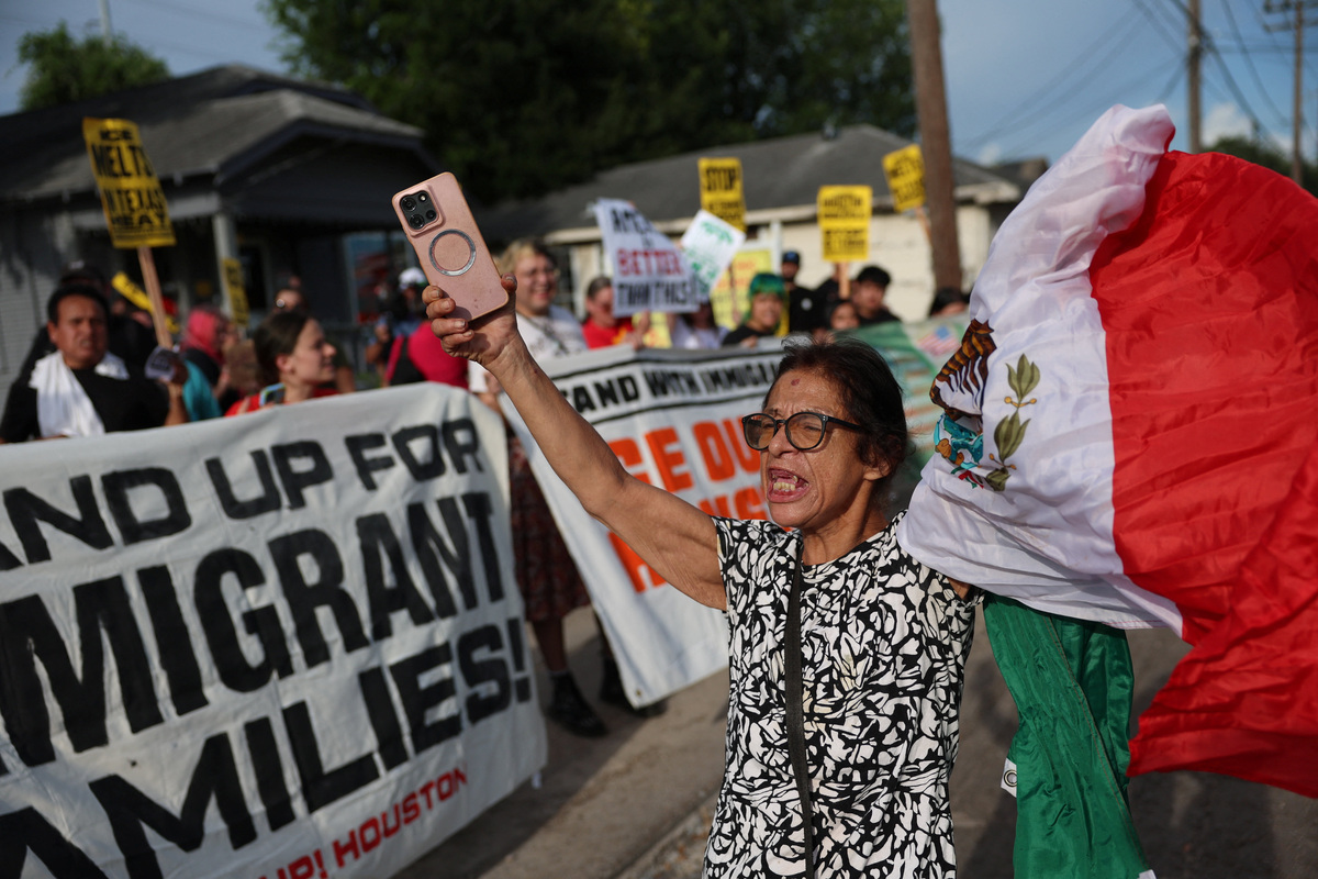 A person holds a Mexican flag during a vigil after the fatal shooting of Mexican motorist Lorenzo Salgado Araujo by an ICE agent in Houston, Texas, U.S., July 8, 2026.  REUTERS/Antranik Tavitian
