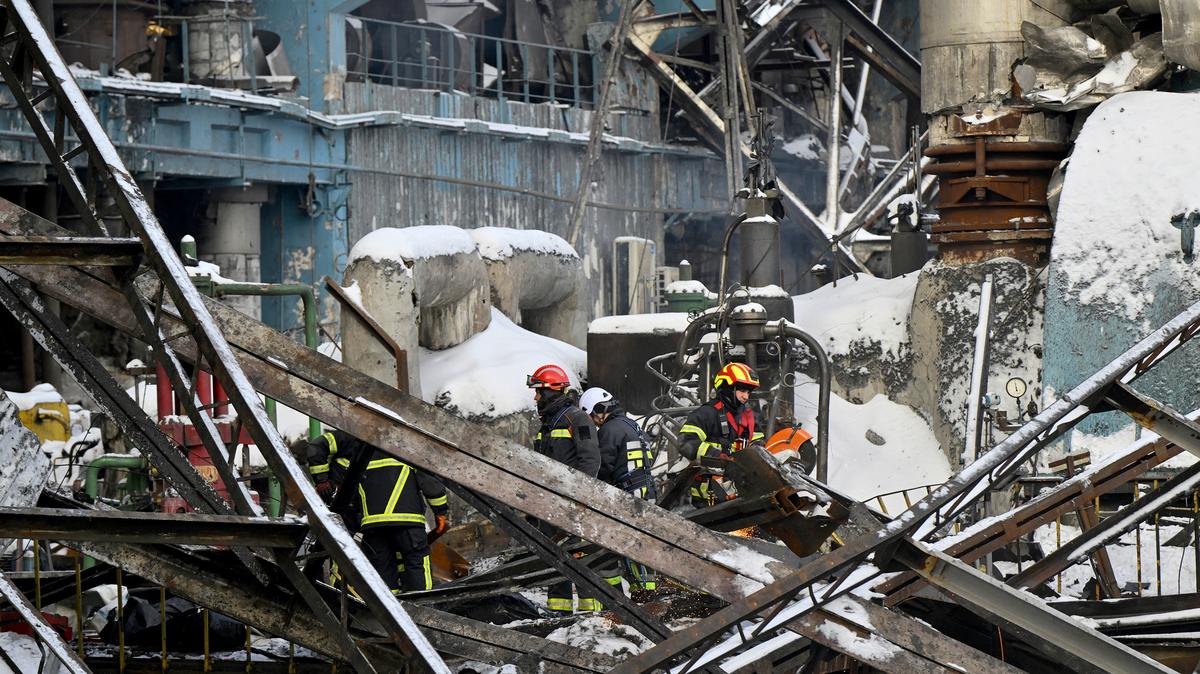 Rescuers of the State Emergency Service and employees of a power plant clear debris at a heavily damaged thermal power plant of the Ukrainian energy provider DTEK in an undisclosed location in Ukraine on Feb. 9, 2026, following Russian missile and drone strikes amid the Russian invasion of Ukraine. (Genya Savilov/AFP/Getty Images/TNS)
