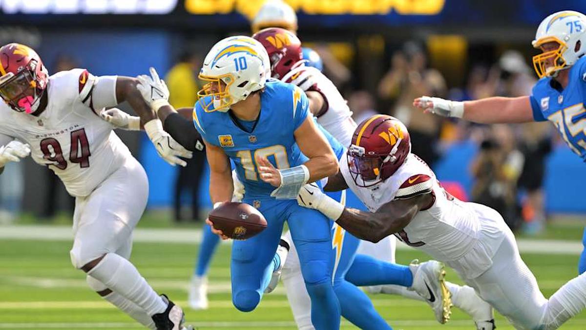  Oct 5, 2025; Inglewood, California, USA; Washington Commanders defensive end Dorance Armstrong (92) sacks Los Angeles Chargers quarterback Justin Herbert (10) in the second half at SoFi Stadium. | Jayne Kamin-Oncea-Imagn Images 