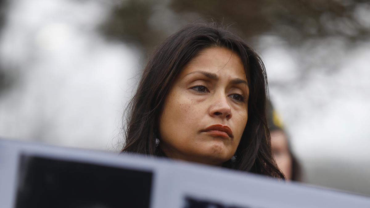 Esmeralda Cantu-Castle, mother of murdered Navy sailor Angelina Resendiz, stands behind a placard of others who suffered the same violence as her daughter during a press conference at Naval Station Norfolk on Friday, Feb. 20, 2026, in Virginia. (Stephen M. Katz/The Virginian-Pilot/TNS)