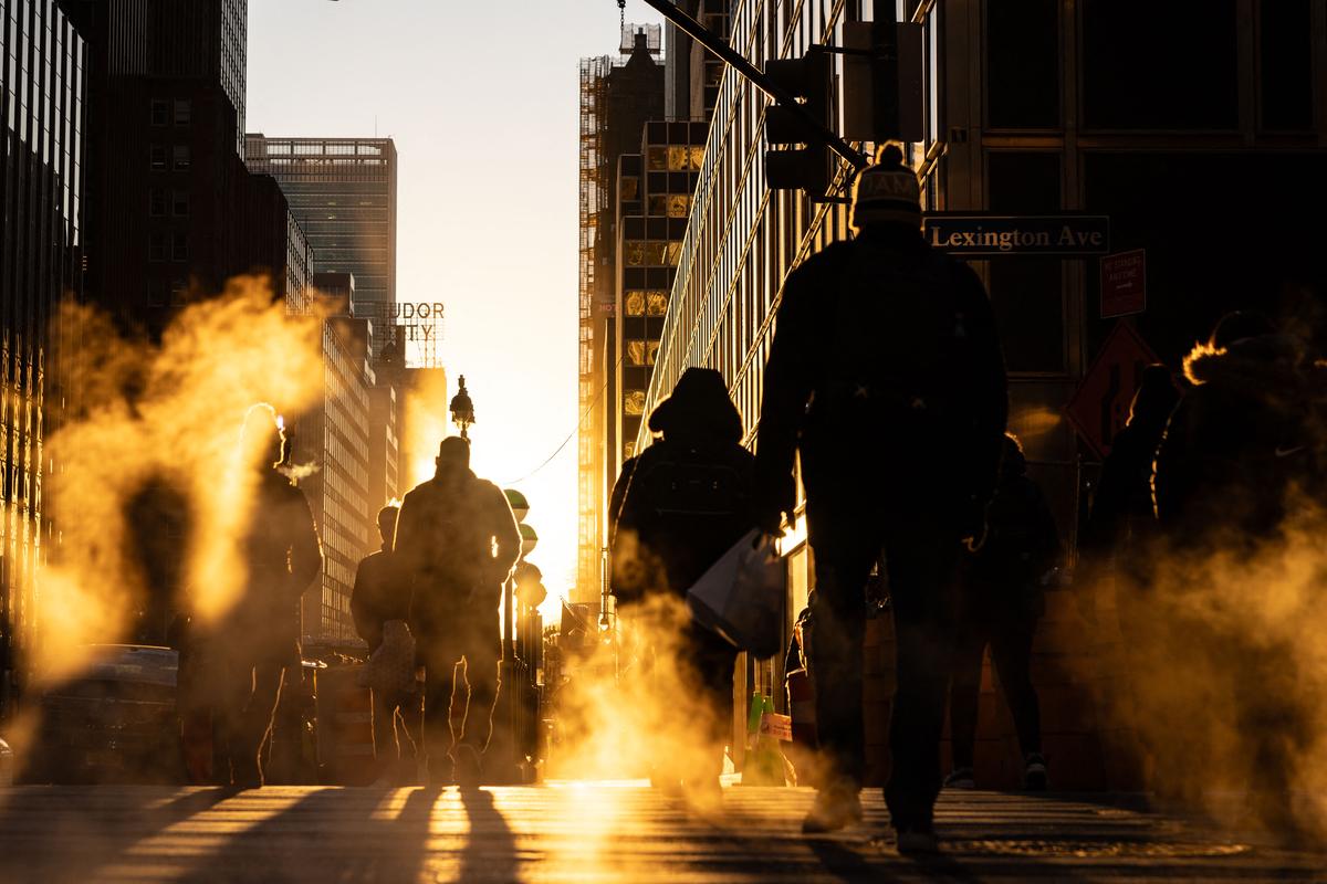  Morning commuters cross the street in New York City on January 30, 2025. 