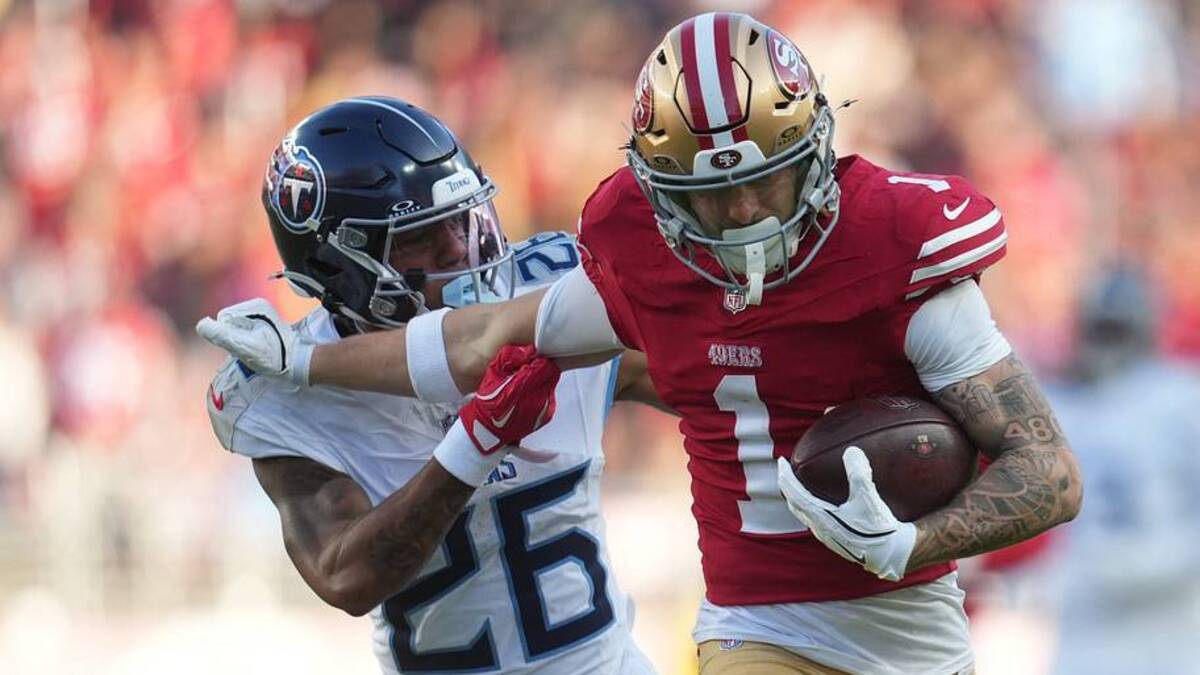  Dec 14, 2025; Santa Clara, California, USA; San Francisco 49ers wide receiver Ricky Pearsall (1) stiff arms Tennessee Titans cornerback Marcus Harris (26) during the third quarter at Levi's Stadium. Mandatory Credit: Cary Edmondson-Imagn Images | IMAGN IMAGES via Reuters Connect 