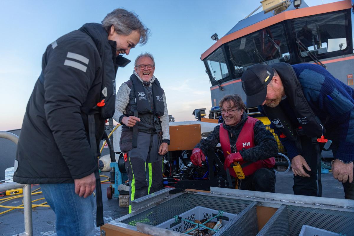 Crew members work to salvage a trove of Chinese porcelain and European-made goods from a recently discovered 18th-century shipwreck off the coast of Norway, at the Skagerrak Sea in this undated handout picture. Sindre Kinnerod /Handout via REUTERS