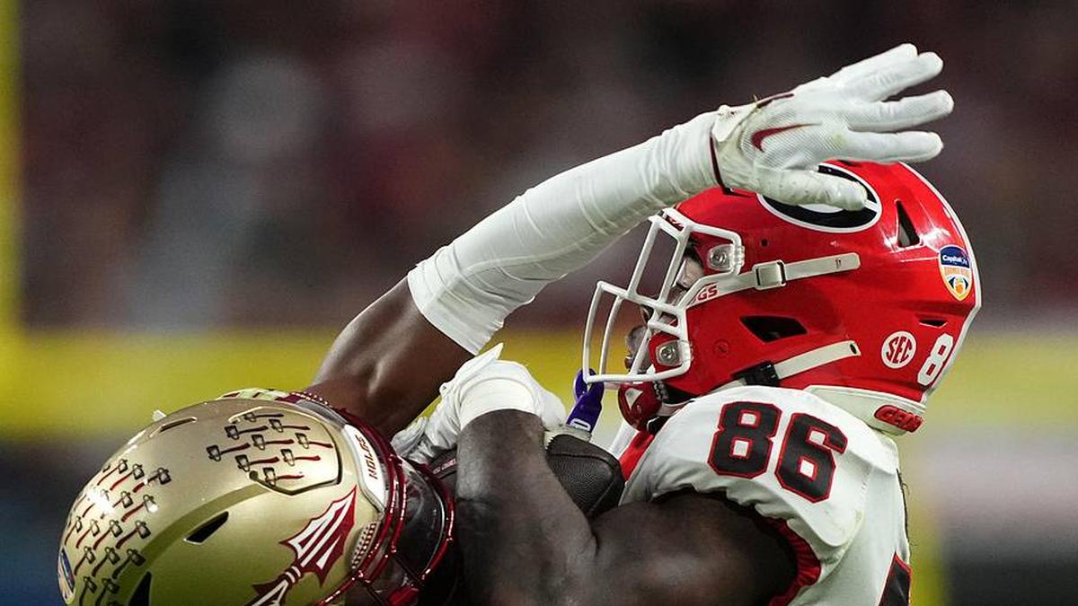  Dec 30, 2023; Miami Gardens, FL, USA; Georgia Bulldogs tight end Pearce Spurlin III (88) makes a catch over Florida State Seminoles linebacker Tatum Bethune (15) during the second half in the 2023 Orange Bowl at Hard Rock Stadium. Mandatory Credit: Jasen Vinlove-Imagn Images | Jasen Vinlove-Imagn Images 