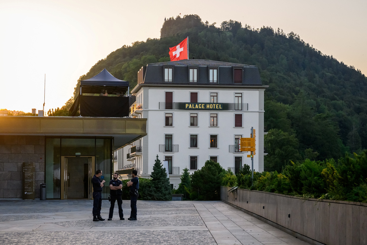 Police officers stand next to a building at the Buergenstock luxury hotel complex overlooking Lake Lucerne, Switzerland, on June 21, 2026, ahead of high-level talks aimed at advancing a deal to end the Middle East conflict.   Fabrice Coffrini/Pool via REUTERS