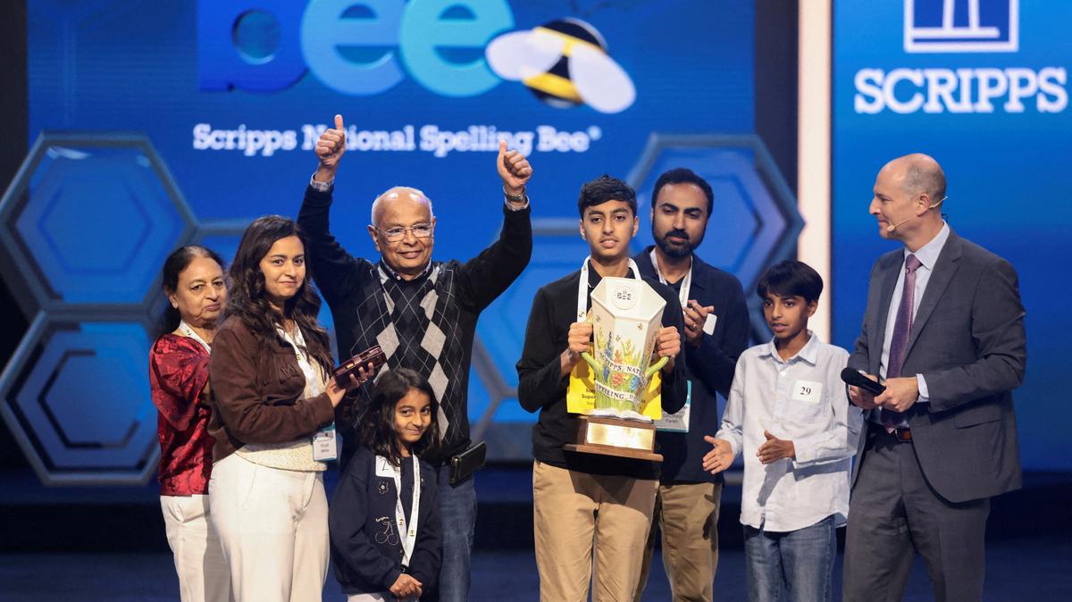 Shrey Parikh holds the trophy as members of his family react, after winning the annual Scripps National Spelling Bee by spelling the word "cashaw", in Washington, D.C., U.S., May 28, 2026. REUTERS/Evelyn Hockstein
