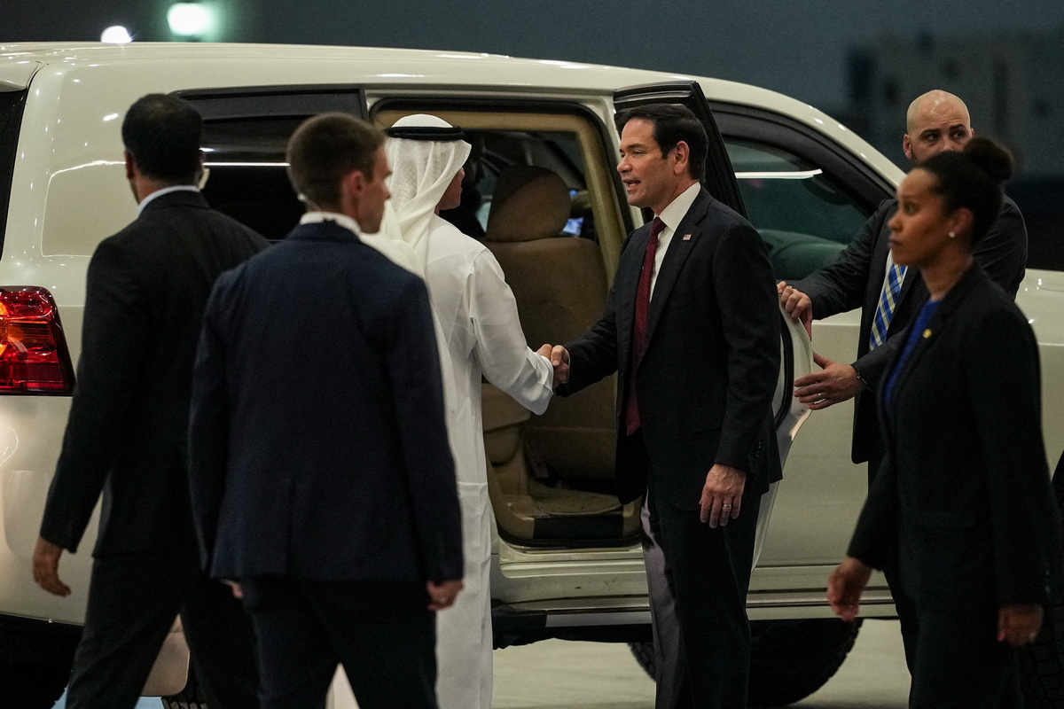 UAE Ambassador to the U.S. Yousef Al Otaiba shakes hands with U.S. Secretary of State Marco Rubio upon his arrival at Al Bateen Executive Airport to discuss the interim deal between the U.S. and Iran with Arab Gulf allies, in Abu Dhabi, United Arab Emirates, June 23, 2026. REUTERS/Eric Lee/Pool