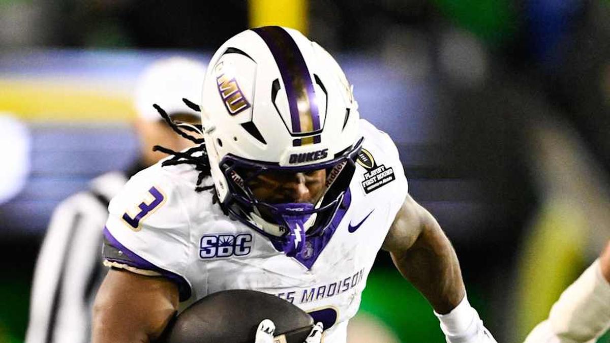  Dec 20, 2025; Eugene, OR, USA; James Madison Dukes running back Wayne Knight (3) rushes as Oregon Ducks defensive back Aaron Flowers (21) defends during the second quarter at Autzen Stadium. Mandatory Credit: Troy Wayrynen-Imagn Images | Troy Wayrynen-Imagn Images 