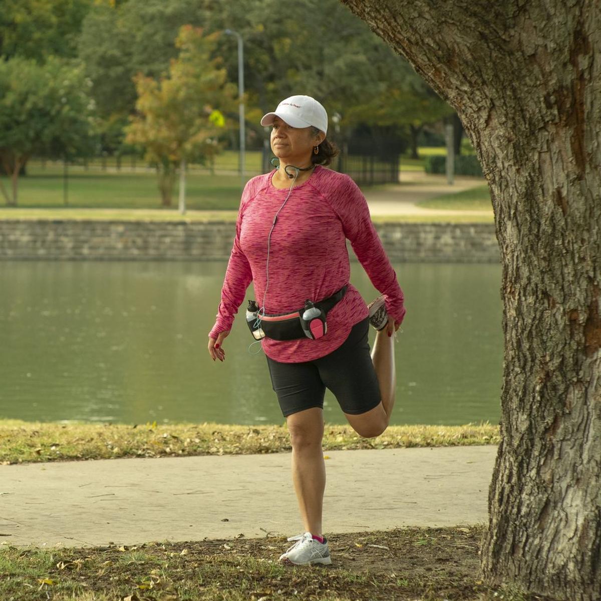  Woman stretching at a park. (American Heart Association via SWNS) 