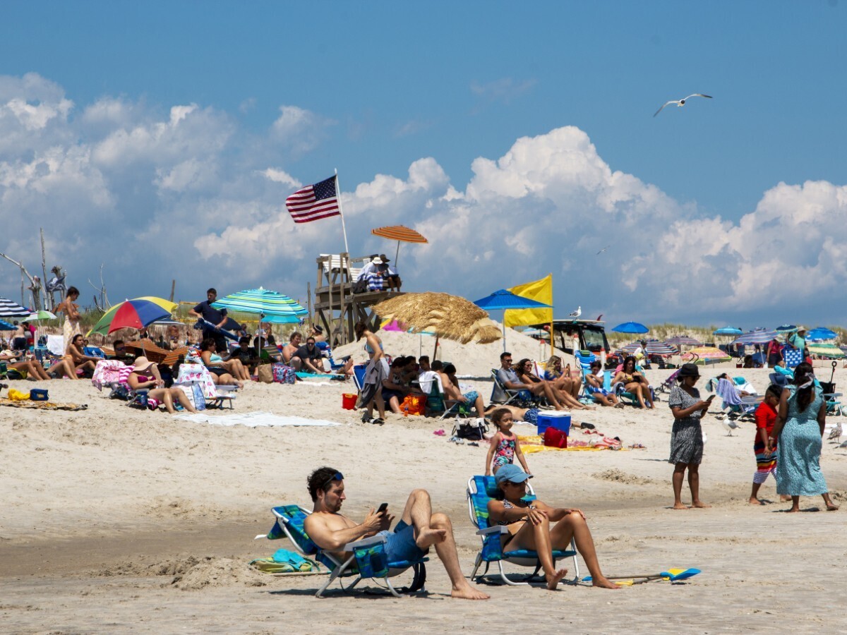  File photo: Americans sit on the beach on Fire Island, Long Island, New York, July 2021. 