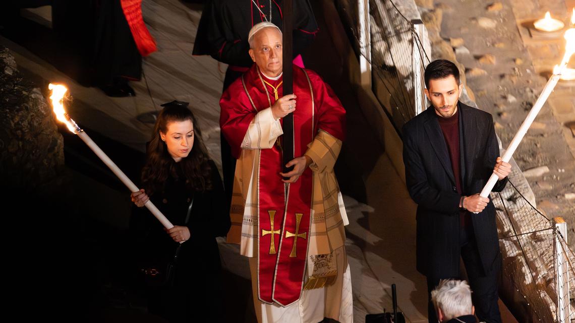 Pope Leo leads Good Friday procession in Rome, carries cross